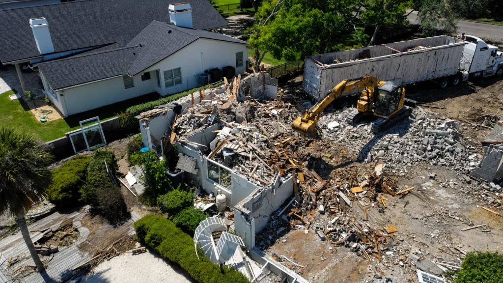 Aerial close view of active demolition work and heavy equipment